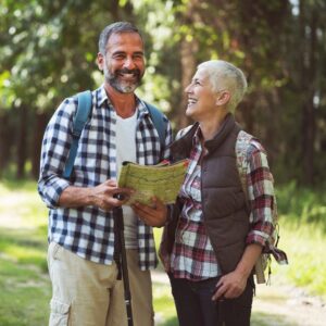 older couple outside with a map