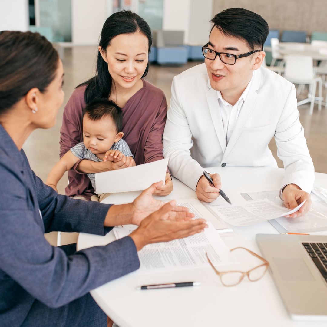 Couple with a baby talking to a financial advisor