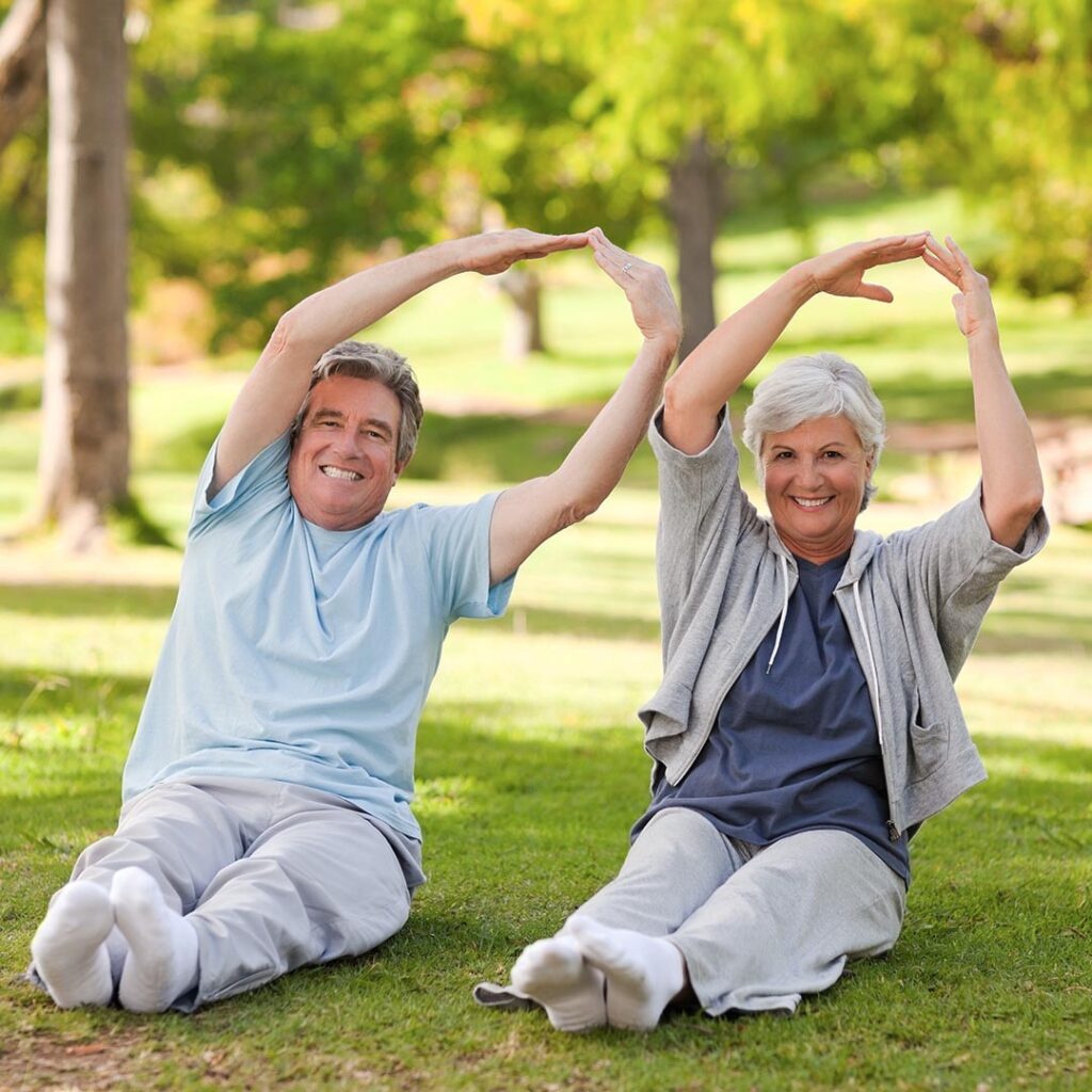 Happy senior couple exercising in the park