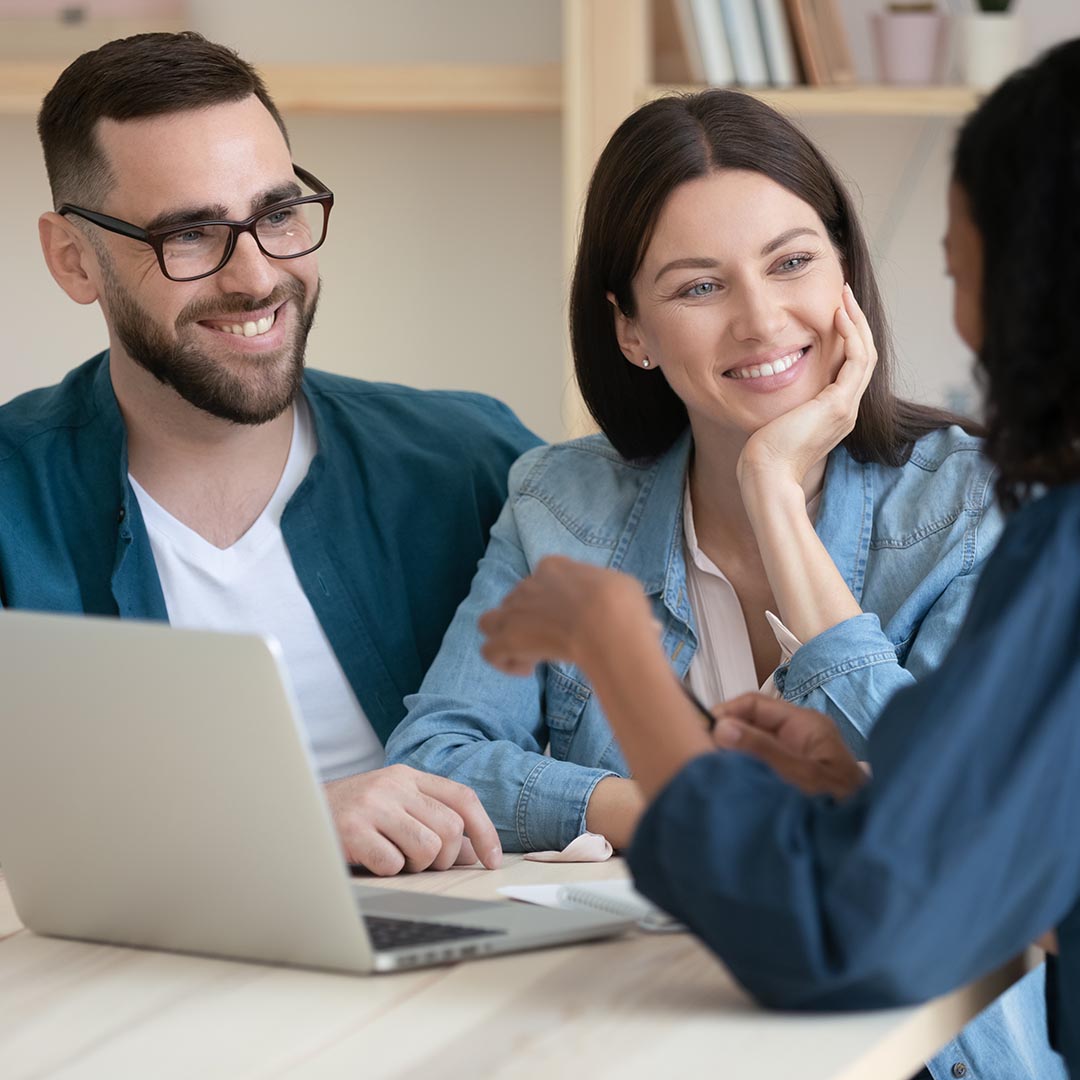 Happy couple talking to a wealth manager