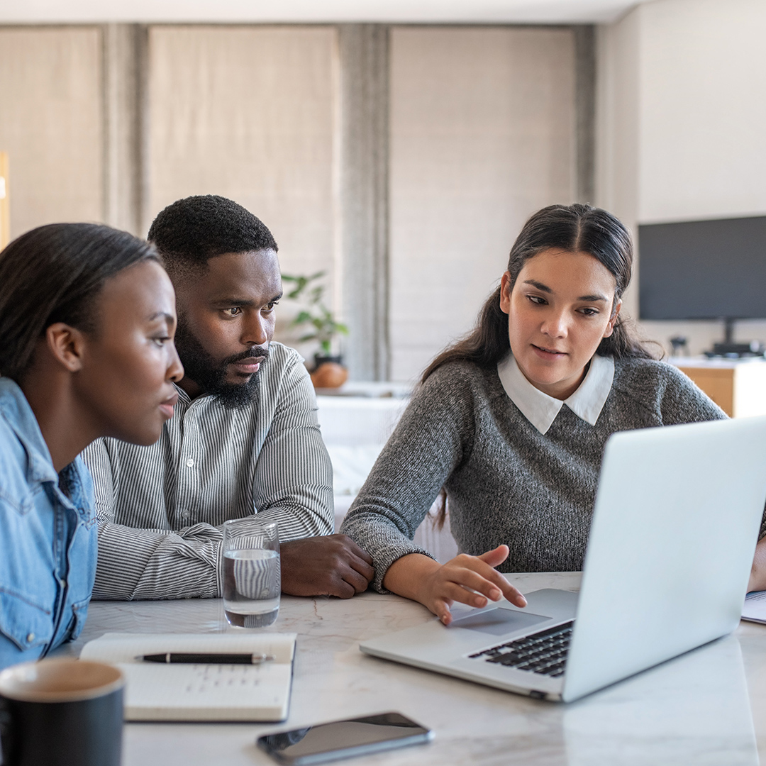 A couple and advisor discussing financial goals 