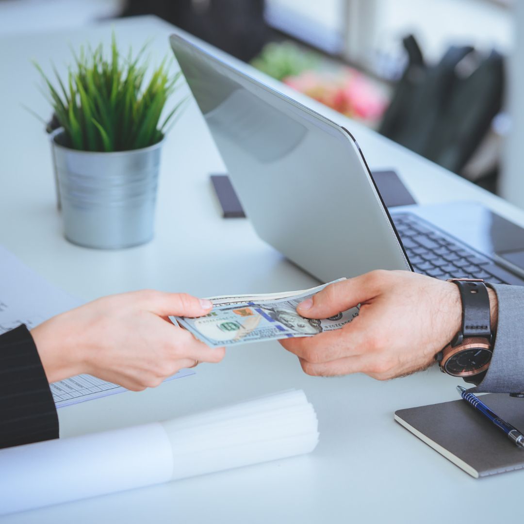 businessman handing over money to a client