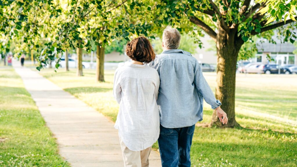 retired couple walking in park