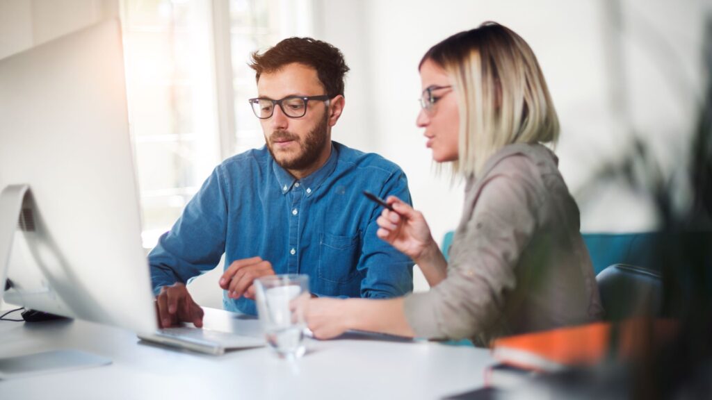 two people working on computer