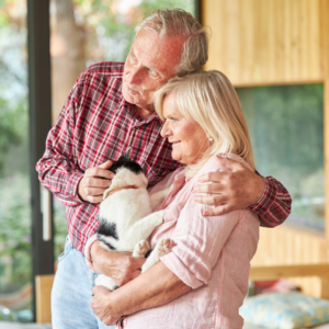 senior couple holding a dog