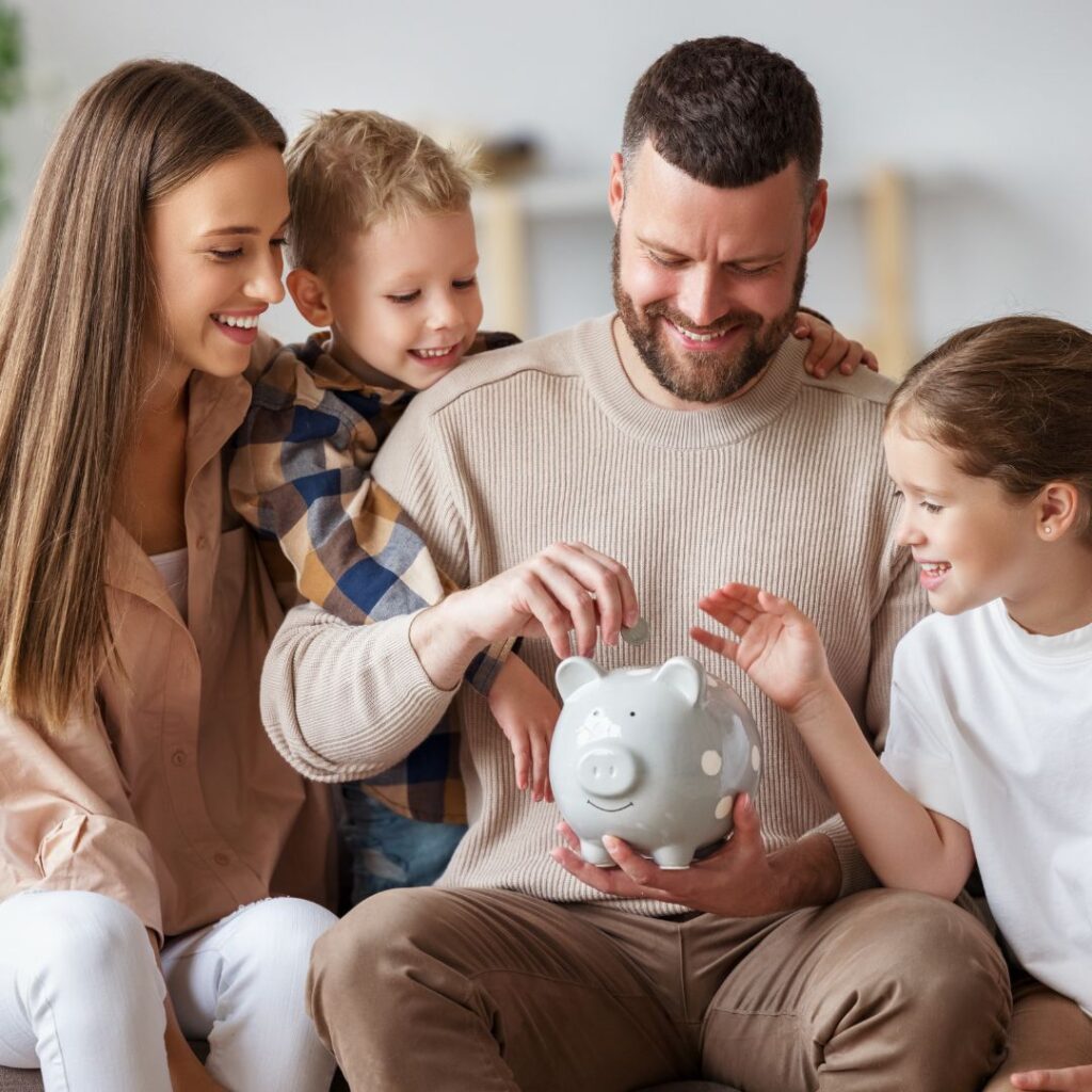family putting money in a piggy bank