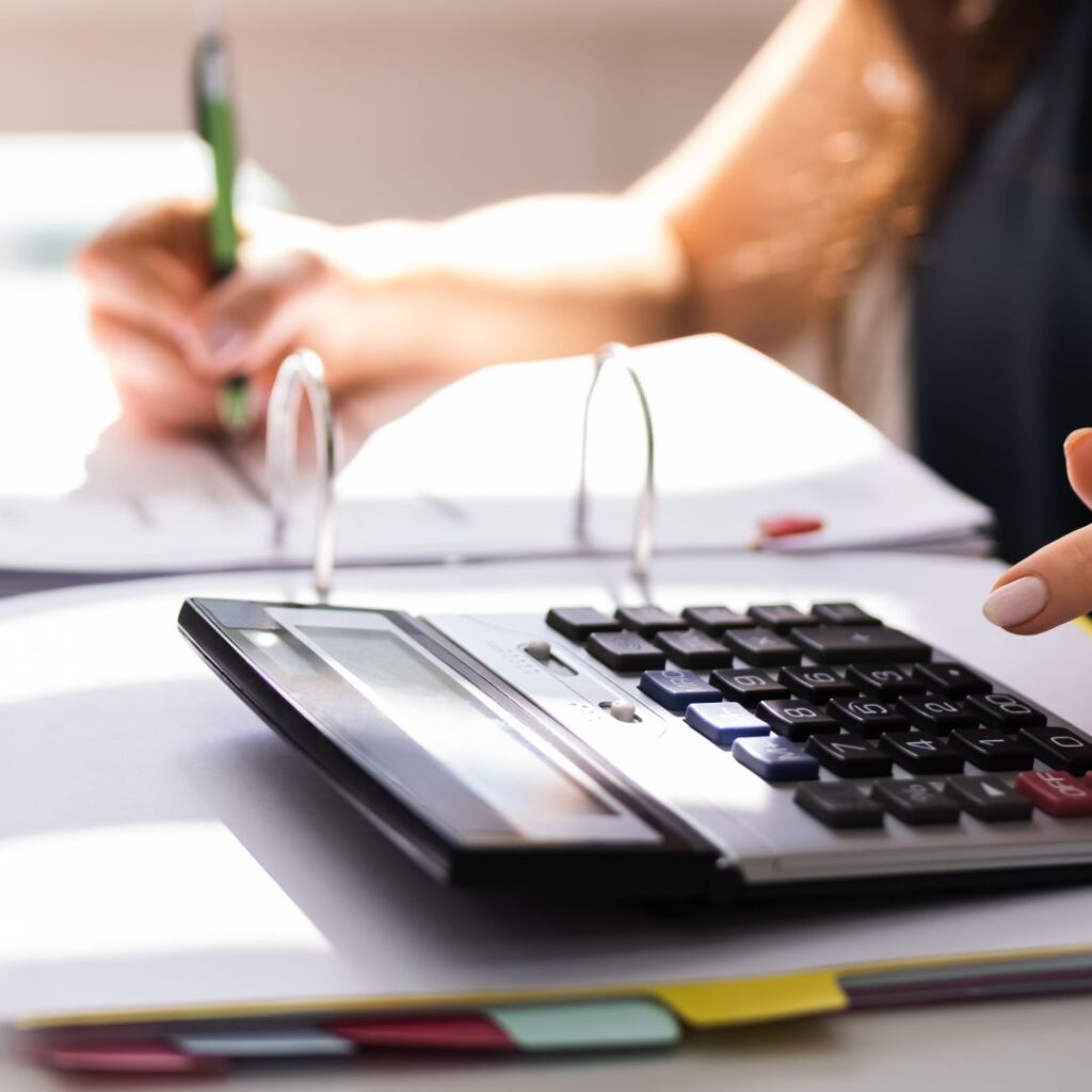 doing taxes, calculator, notebook