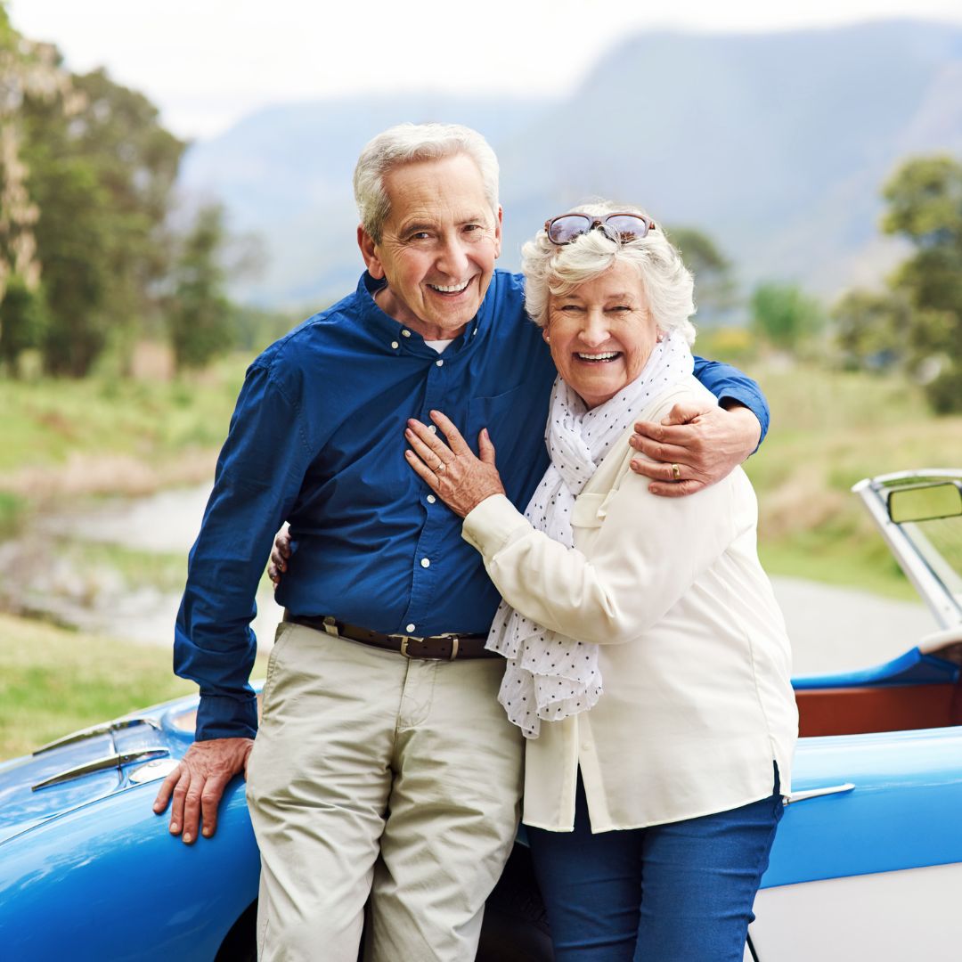 happy senior couple and their car