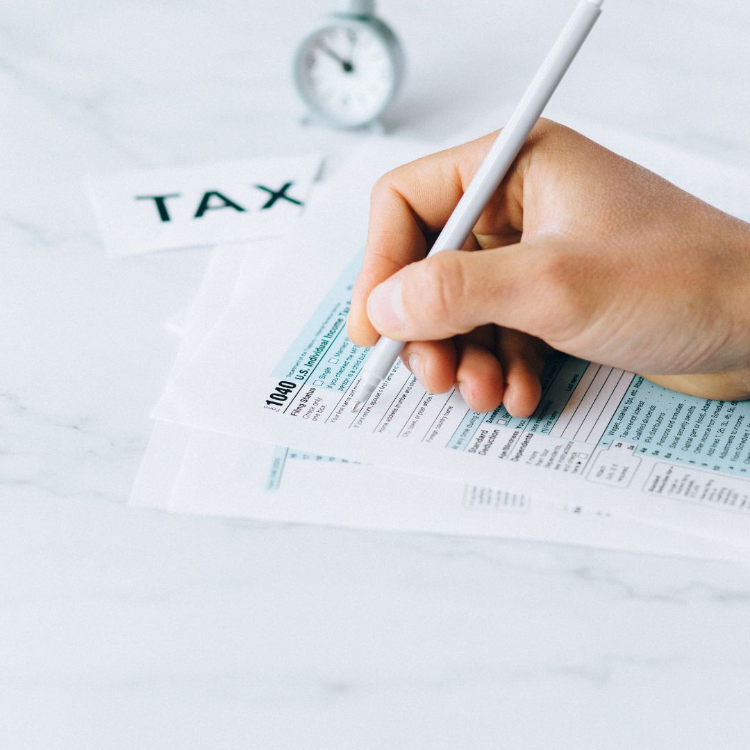 a person filing out tax forms by hand
