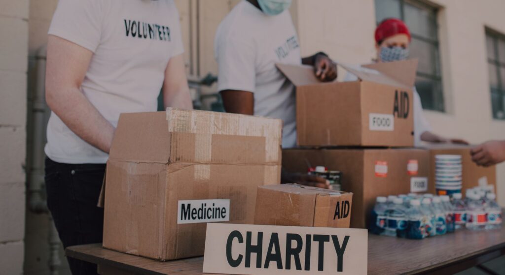 a table full of donation boxes and a sign that says charity