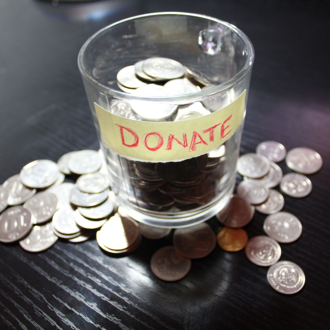 a cup labeled donation with coins in it