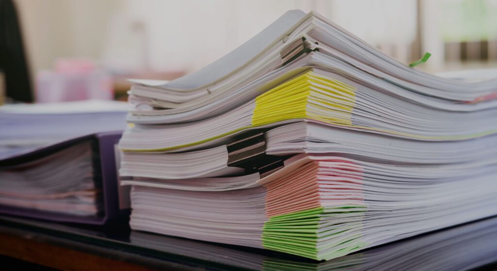 a stack of papers with binder clips