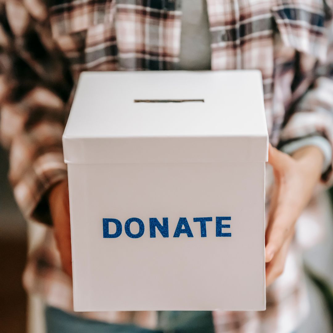a person holding a donate box