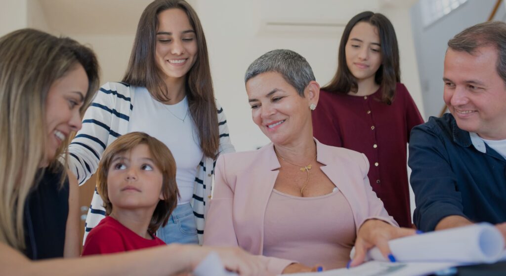 a family smiling and looking at the youngest boy