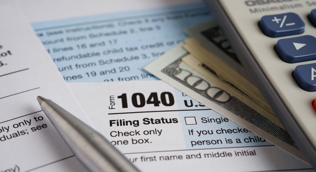 Tax form with cash on top of it