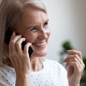 woman holds phone to her ear 