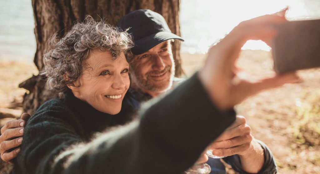 couple taking picture with smartphone outside