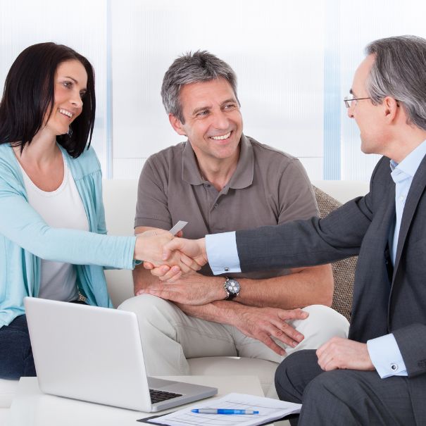 Couple shaking financial advisor's hand