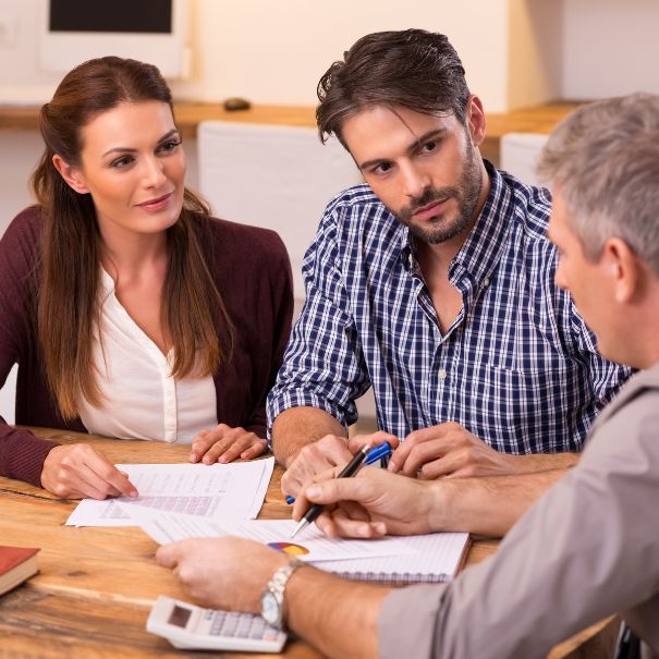 Couple discussing early retirement account withdrawal with their financial advisor