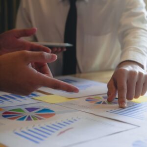 people looking at financial papers