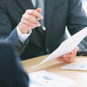 people looking at financial papers